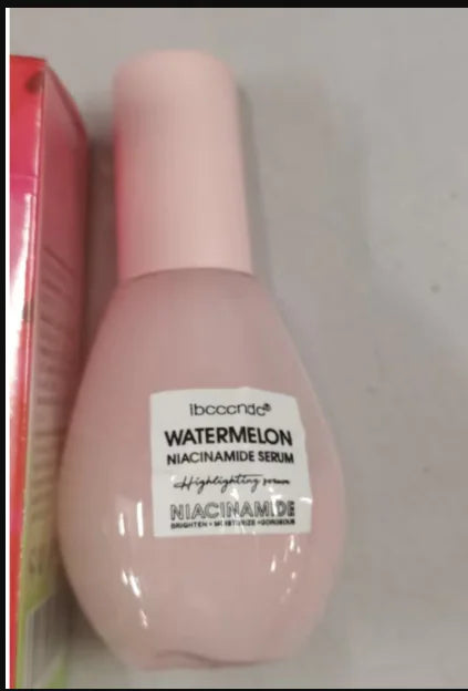 Pink serum bottle with a label on a gray background