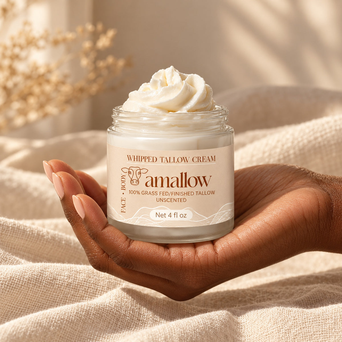 4 fl oz amallow whipped tallow jar resting in a hand for size