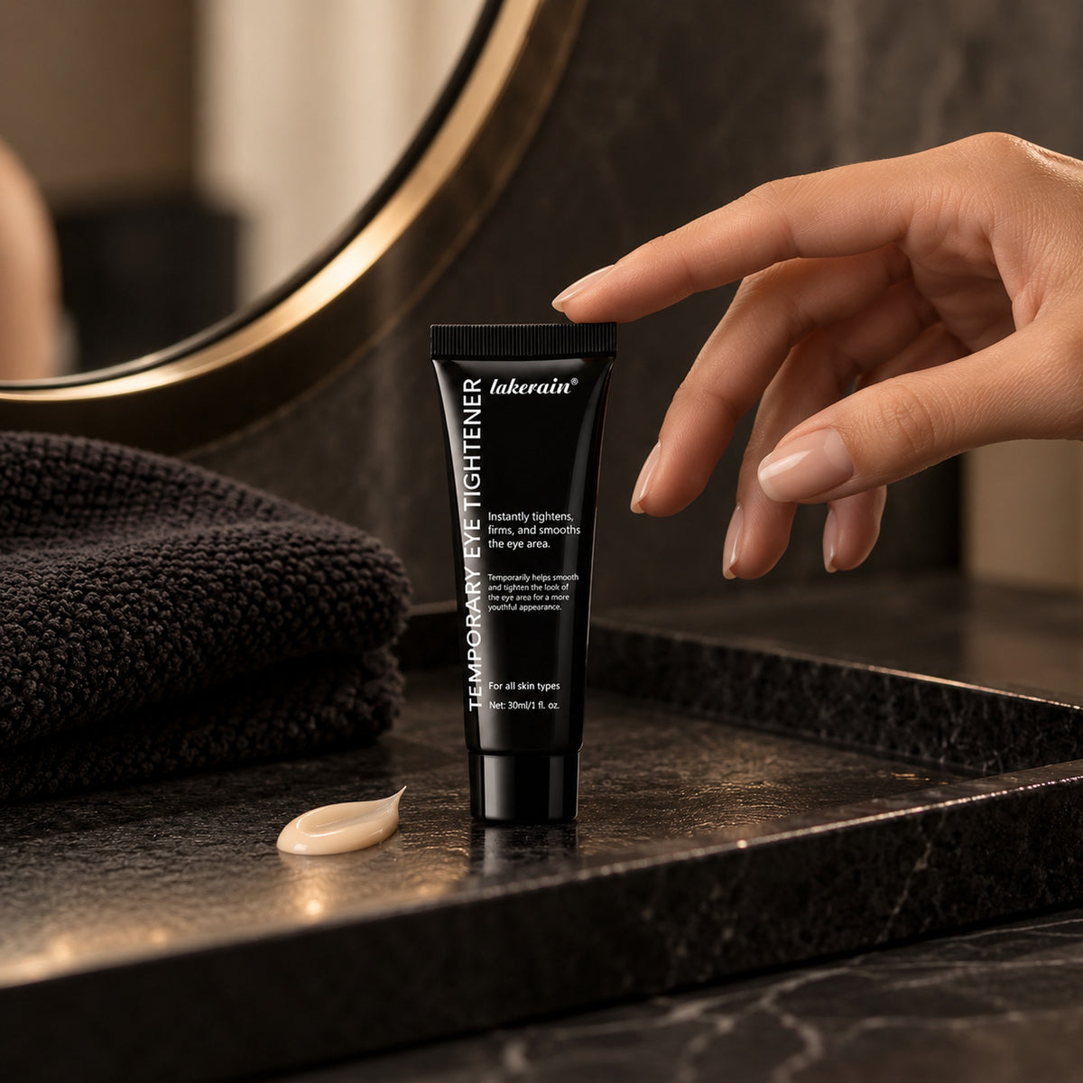 Eye tightener tube on a dark marble vanity with a beige cream swatch