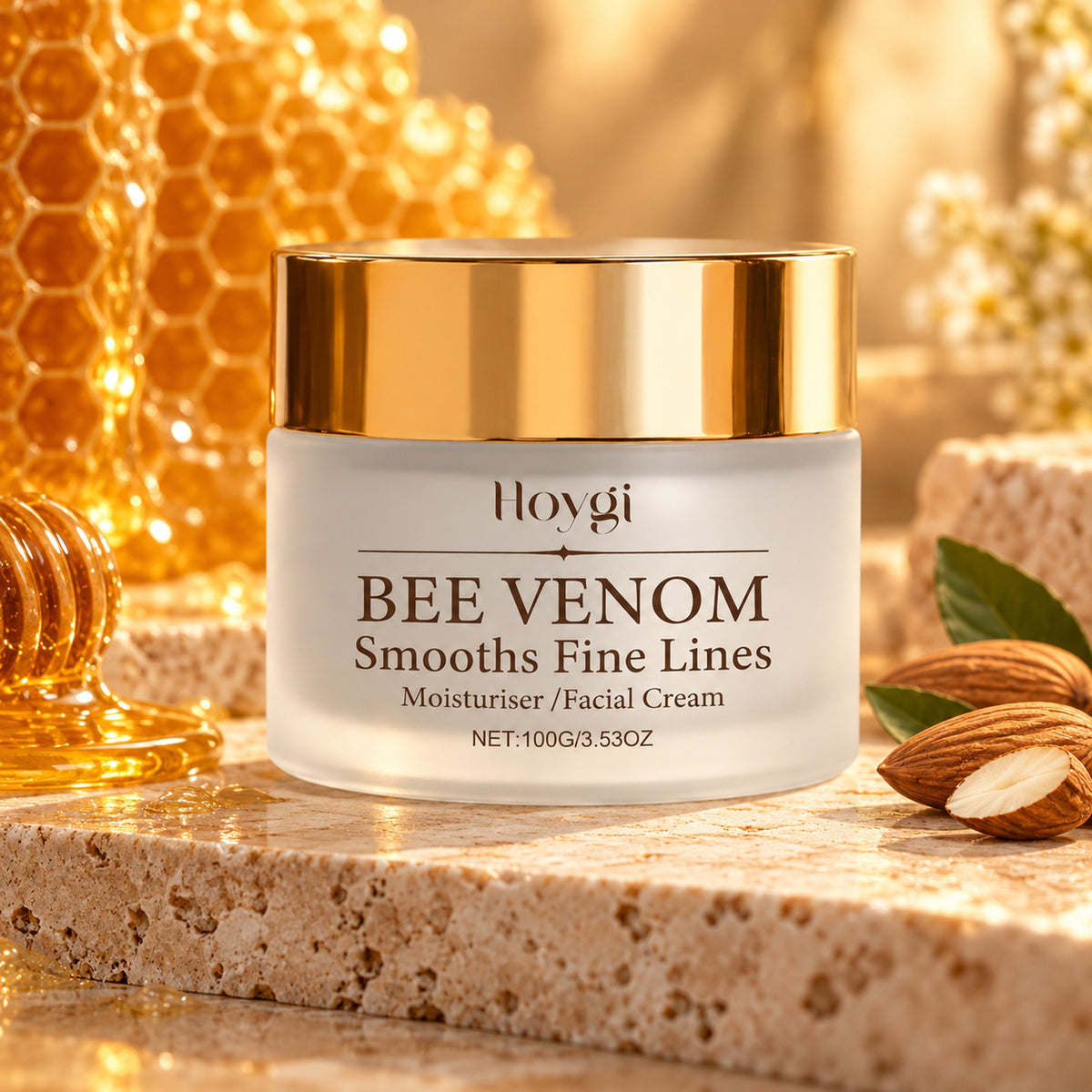 Hoygi Bee Venom face cream jar on travertine with honeycomb and sweet almonds