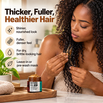 Woman smoothing MBOAH Batana Oil hair cream through her curls – thicker, fuller, healthier-looking hair