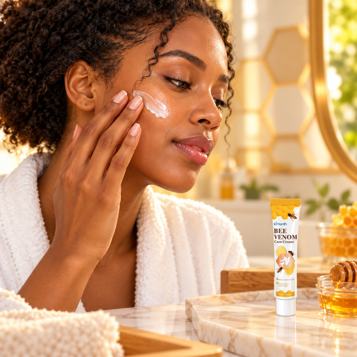 Woman in a bathrobe applying Bee Venom Care Cream at a warm honey-toned vanity