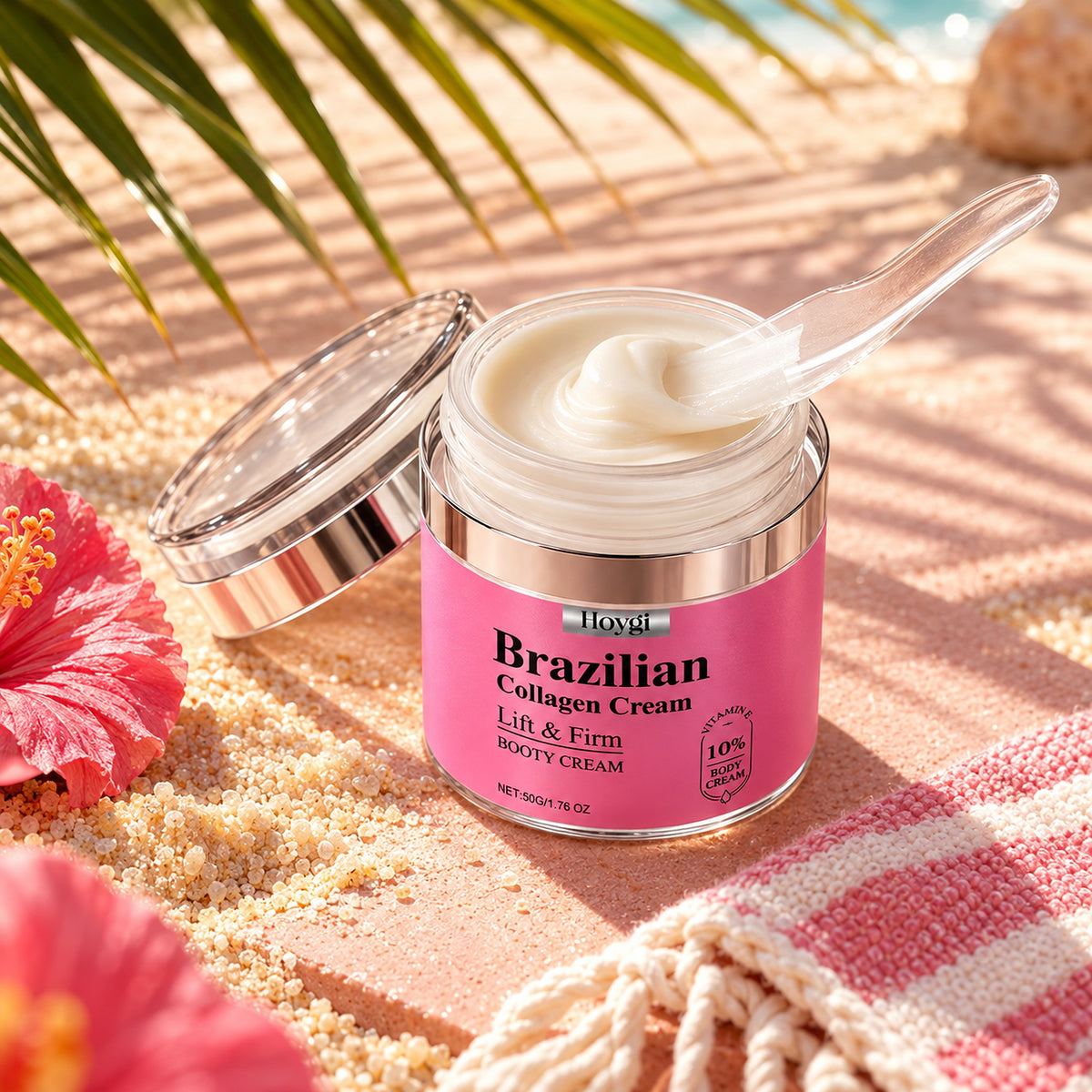 Open jar of Hoygi Brazilian Collagen Cream on warm sand with palm-leaf shadow and a pink beach towel