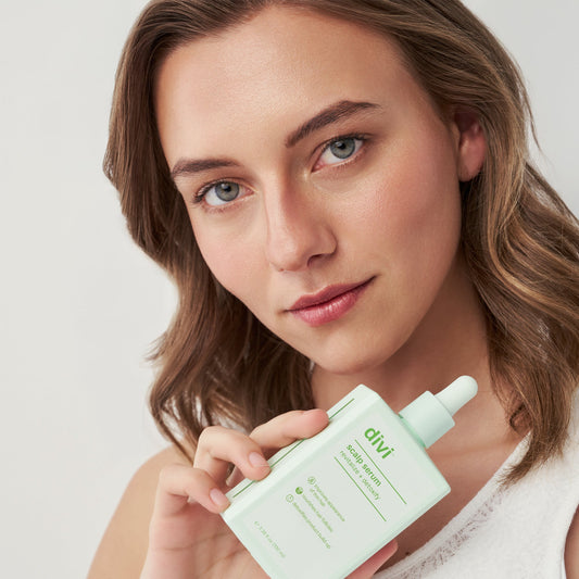 Woman holding Divi Scalp Serum for fuller-looking hair