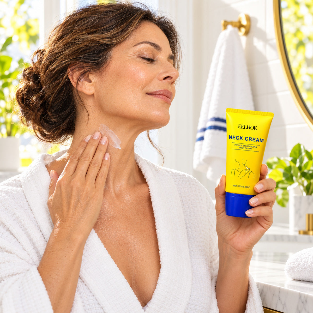 Woman smoothing neck cream upward along her neck