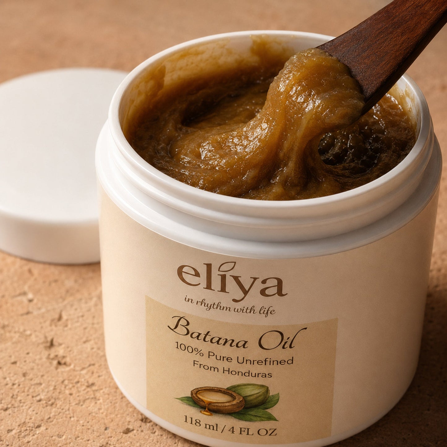 Open Eliya Batana Oil jar showing its dense amber-brown texture in macro detail