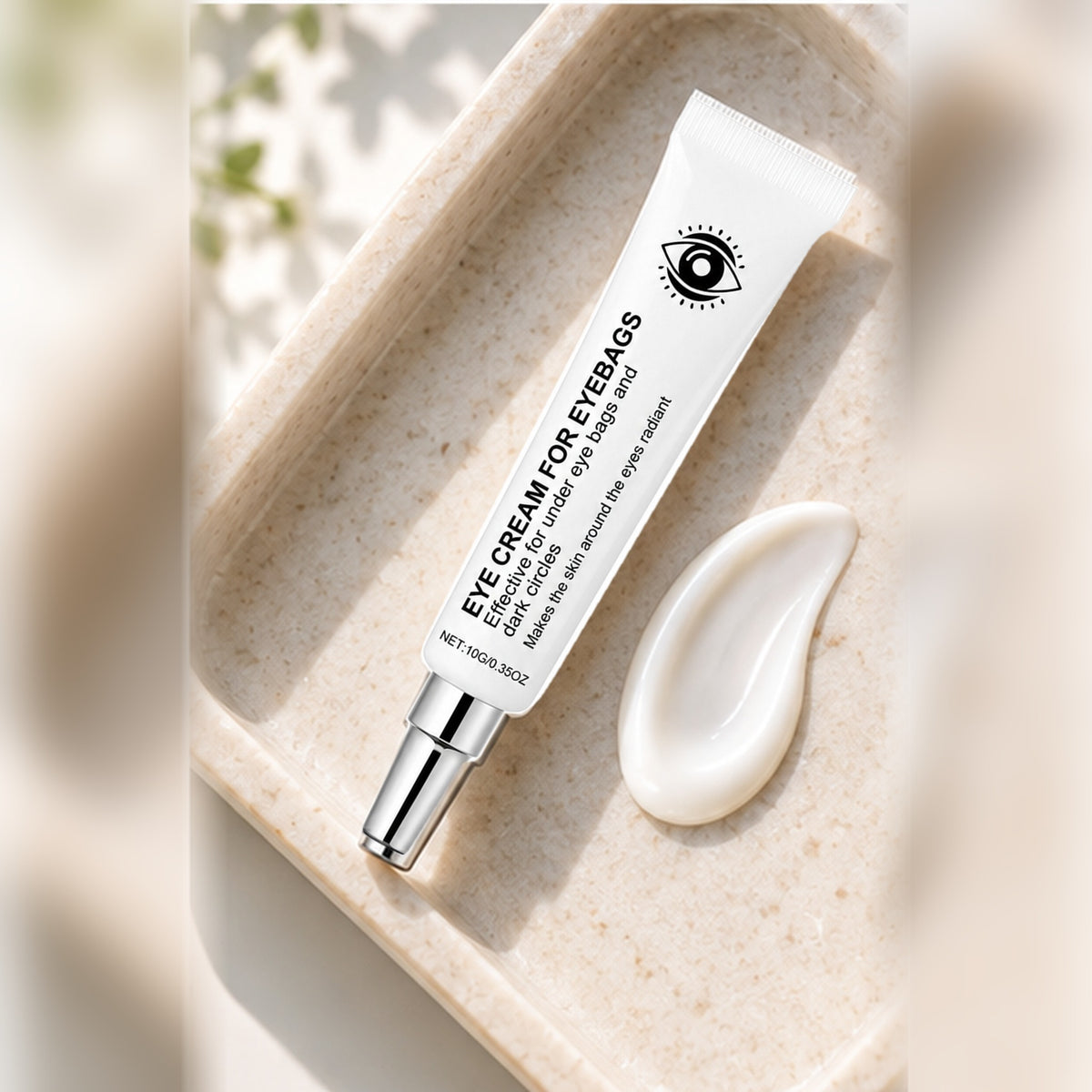 10 g eye cream tube on a pale stone tray with a swirl of cream