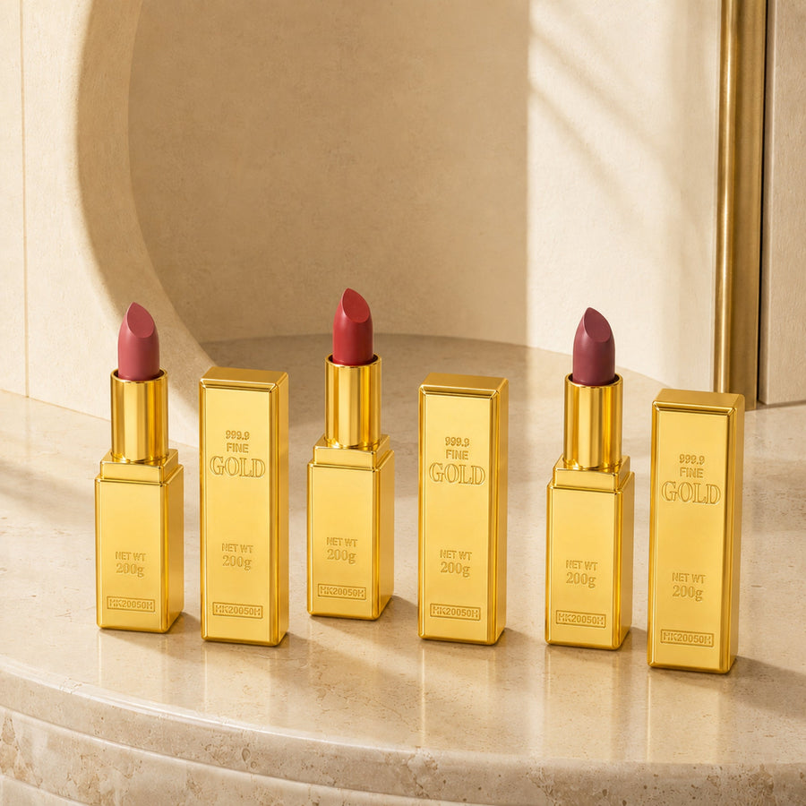 Six gold-bar lipsticks in a warm ivory travertine three-quarter luxury setting