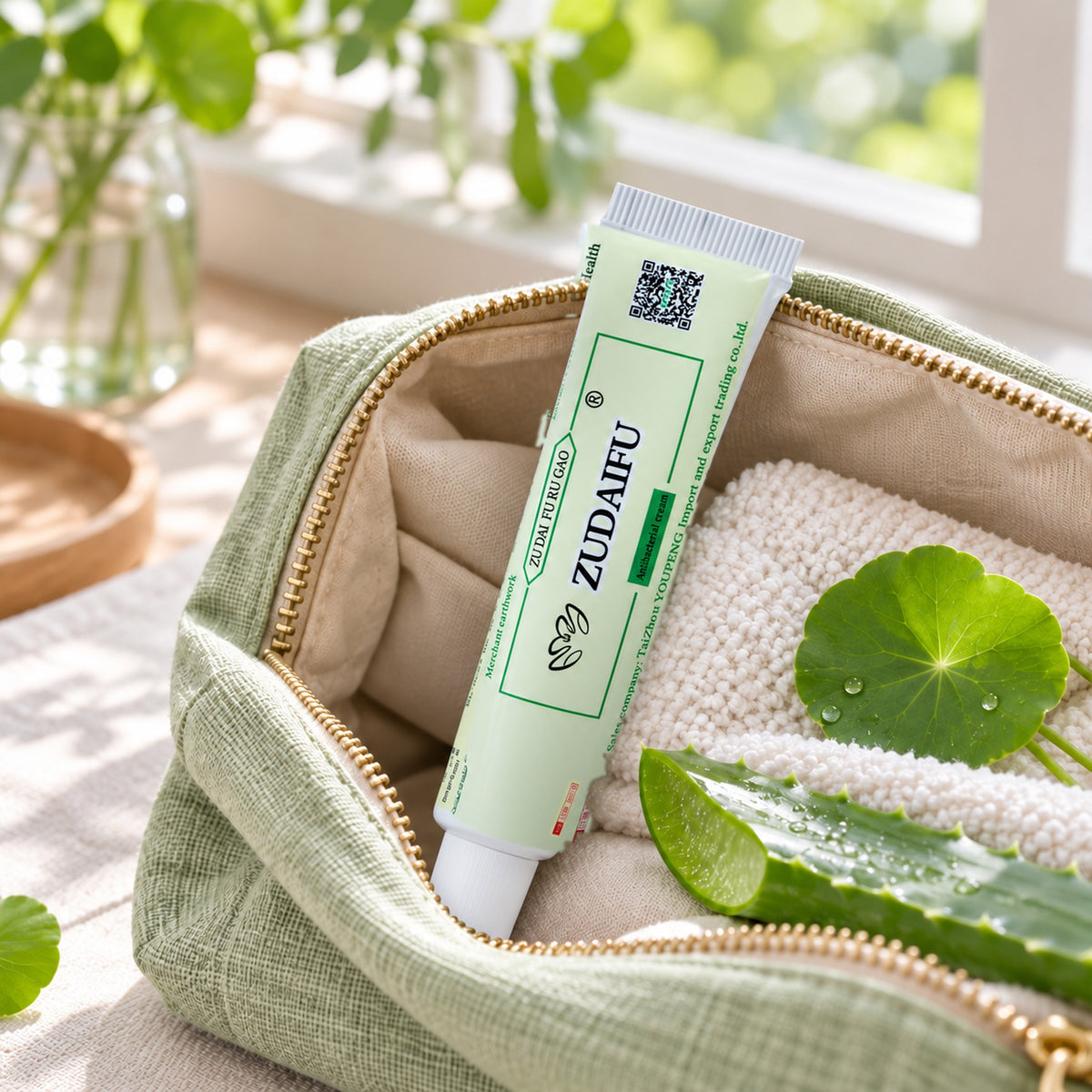 Compact 15 g herbal cream tube in a linen toiletry bag for travel and on-the-go care