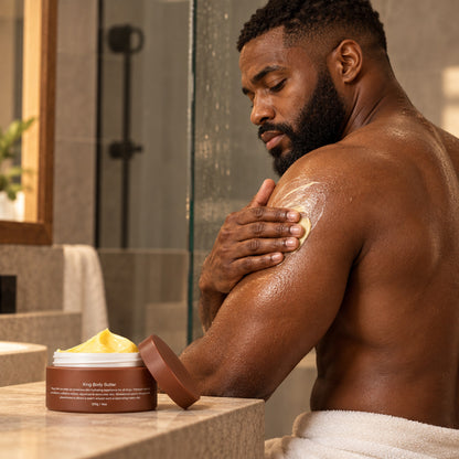 Bearded man massaging King Body Butter into his shoulder after the shower