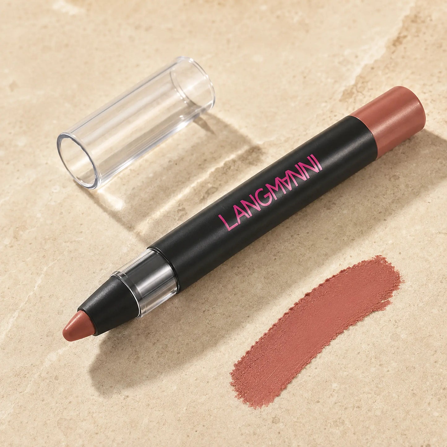Close-up of a LANGMANNI matte lipstick pencil with clear cap and nude color swatch