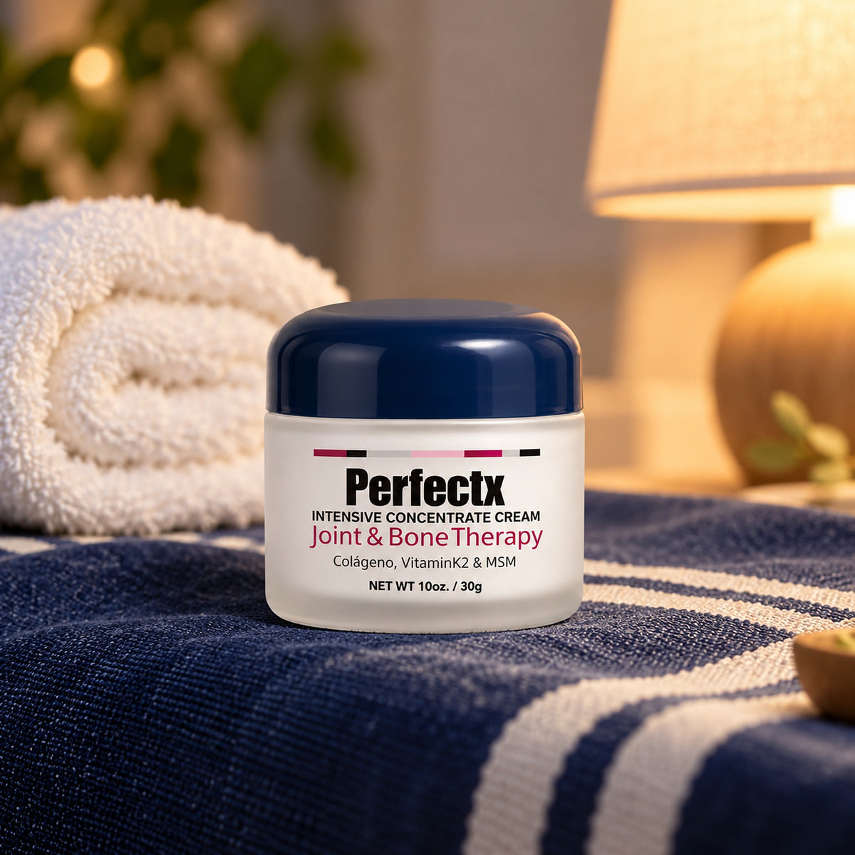 Perfectx navy-lid balm jar on navy and white linen in evening lamp light