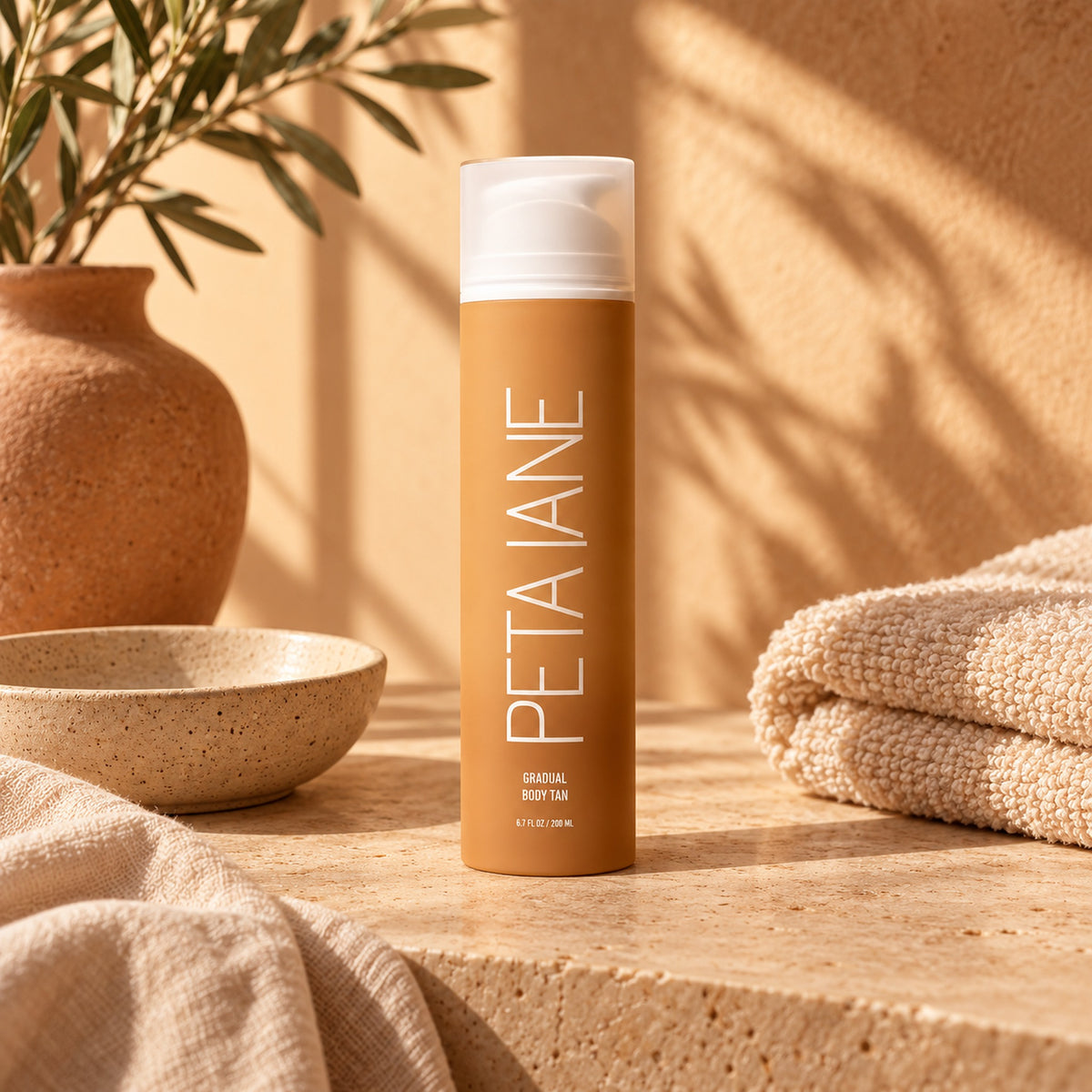 PETA JANE gradual body tan on warm stone with ceramics and towels in golden light
