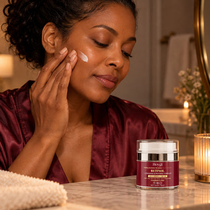 Woman applying Hoygi retinol cream to her face in the evening