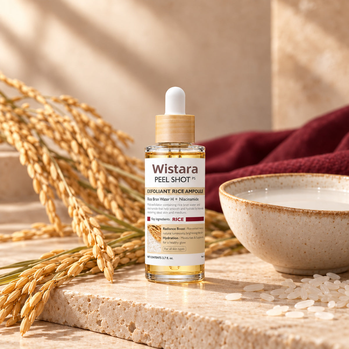 Wistara rice ampoule on stone with golden rice stalks and a bowl of rice water