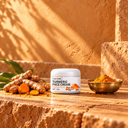 SAUVASINE Turmeric Face Cream jar on warm stone with turmeric roots and a brass bowl of turmeric powder