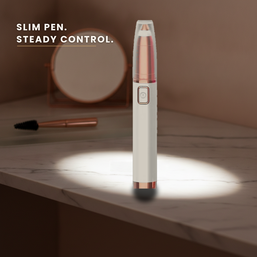 Slim eyebrow trimmer pen standing on a marble vanity ledge in a pool of light